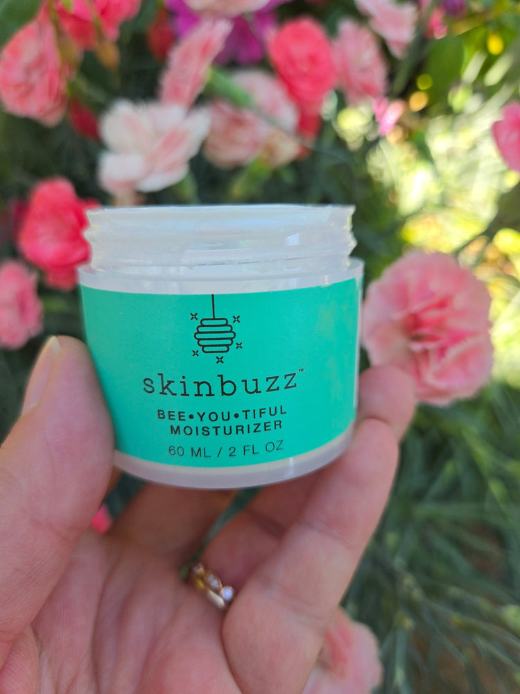 skinbuzz moisturizer with flowers in garden