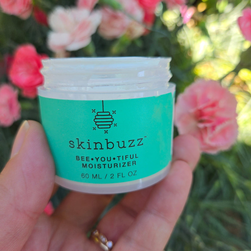 skinbuzz moisturizer with flowers in garden