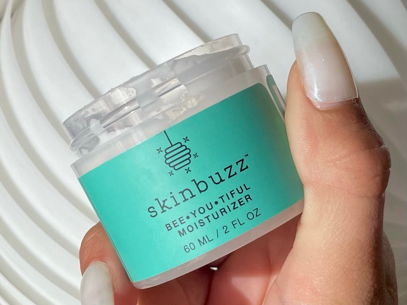 Skinbuzz Bee•You•Tiful Moisturizer, an organic skincare product with beeswax, perfect for summer hydration.